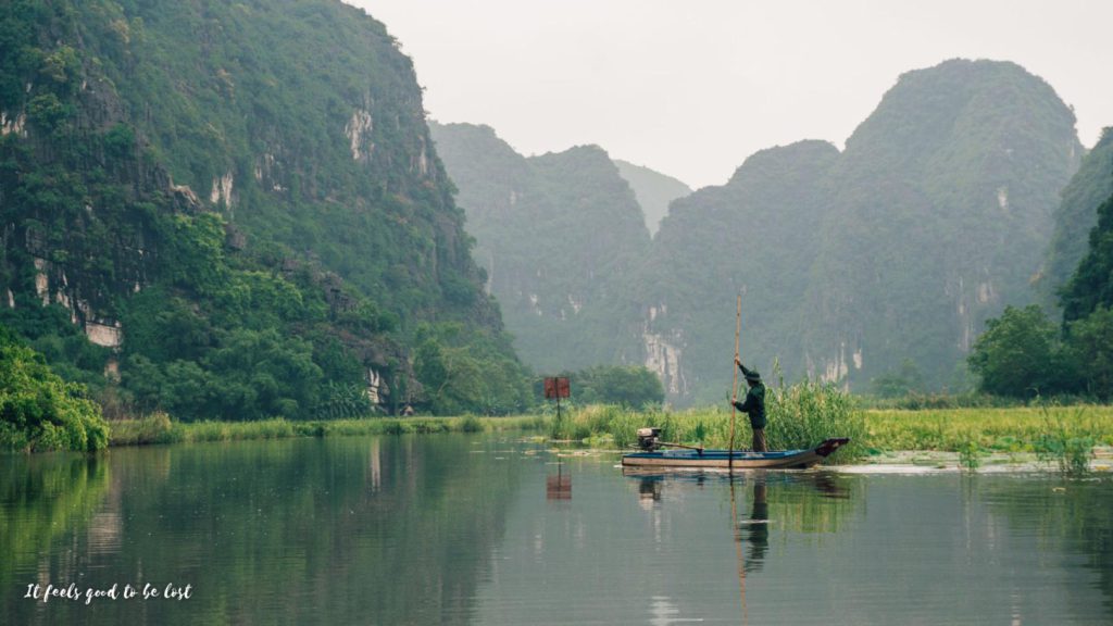 A man padling in a lake in Ninh Binh